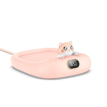 Pink electric mug warmer with a cute cat figurine and digital temperature display